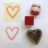 Hand block printed vine heart design onto fabric and paper in red textile paint, Indian wooden printing block