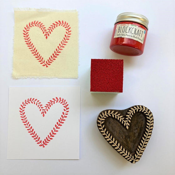 Hand block printed vine heart design onto fabric and paper in red textile paint, Indian wooden printing block