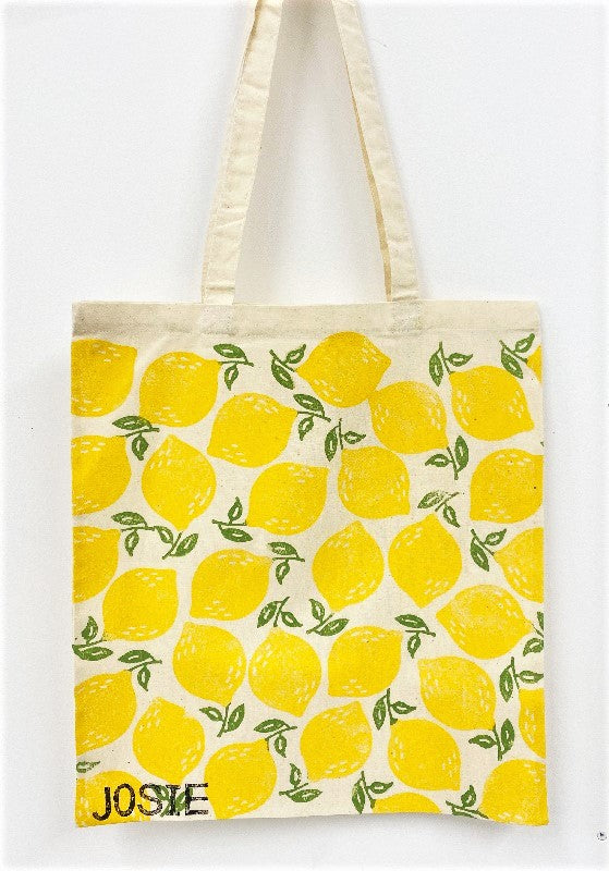 A hand block printed tote bag in a leafy lemon design, printed in fabric paint