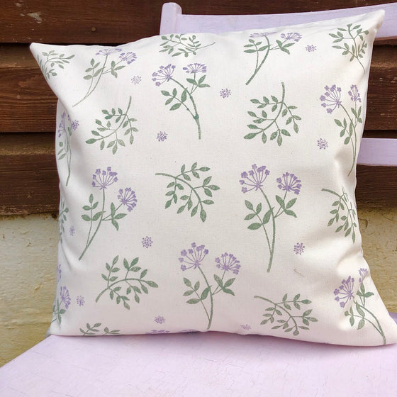 A hand printed cushion in a botanical design, hand printed using Indian printing blocks and a fabric paint in Oxfordshire