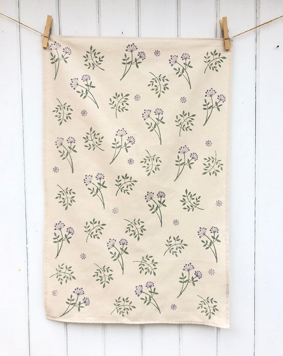 A hand block printed Tea Towel in a botanical floral design, printed using fabric paint
