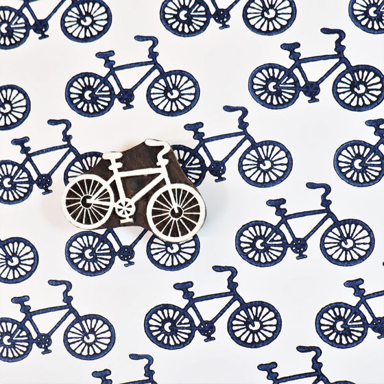 A hand carved Indian wooden printing block in a Bicycle design, hand printed onto paper using acrylic paper