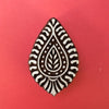 A hand carved Indian wooden printing block in a Paisley design.