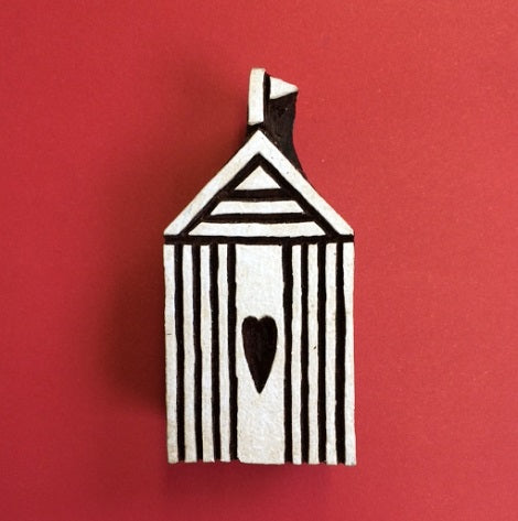 A hand carved Indian wooden printing block in a Beach Hut design