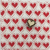 A piece of block printed fabric in a red heart design