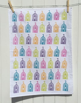 A hand block printed tea towel in a multi coloured block print design