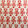 Hand block printed fabric printed using a wooden printing block in red fabric paint