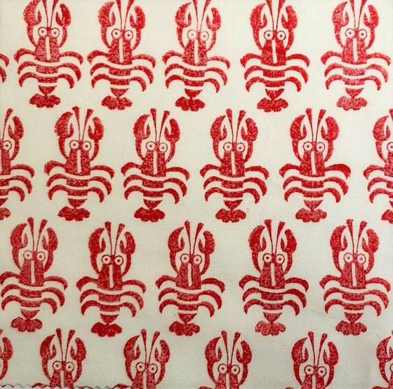 Hand block printed fabric printed using a wooden printing block in red fabric paint