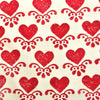 A hand block printed piece of fabric in a red heart motif design