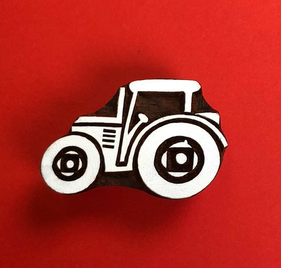 A Indian wooden printing block in a Tractor design
