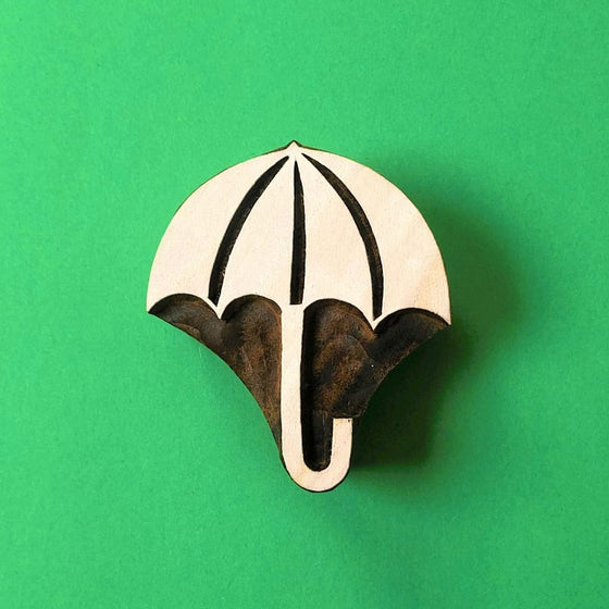 A hand carved Indian wooden printing block in an Umbrella design