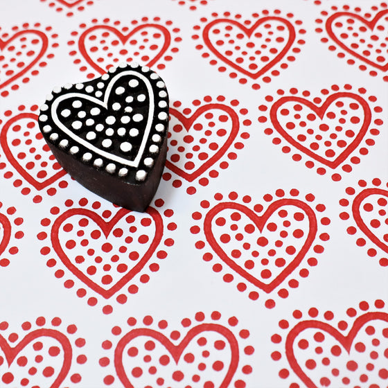 A hand carved Indian wooden printing block, in a dotty heart design